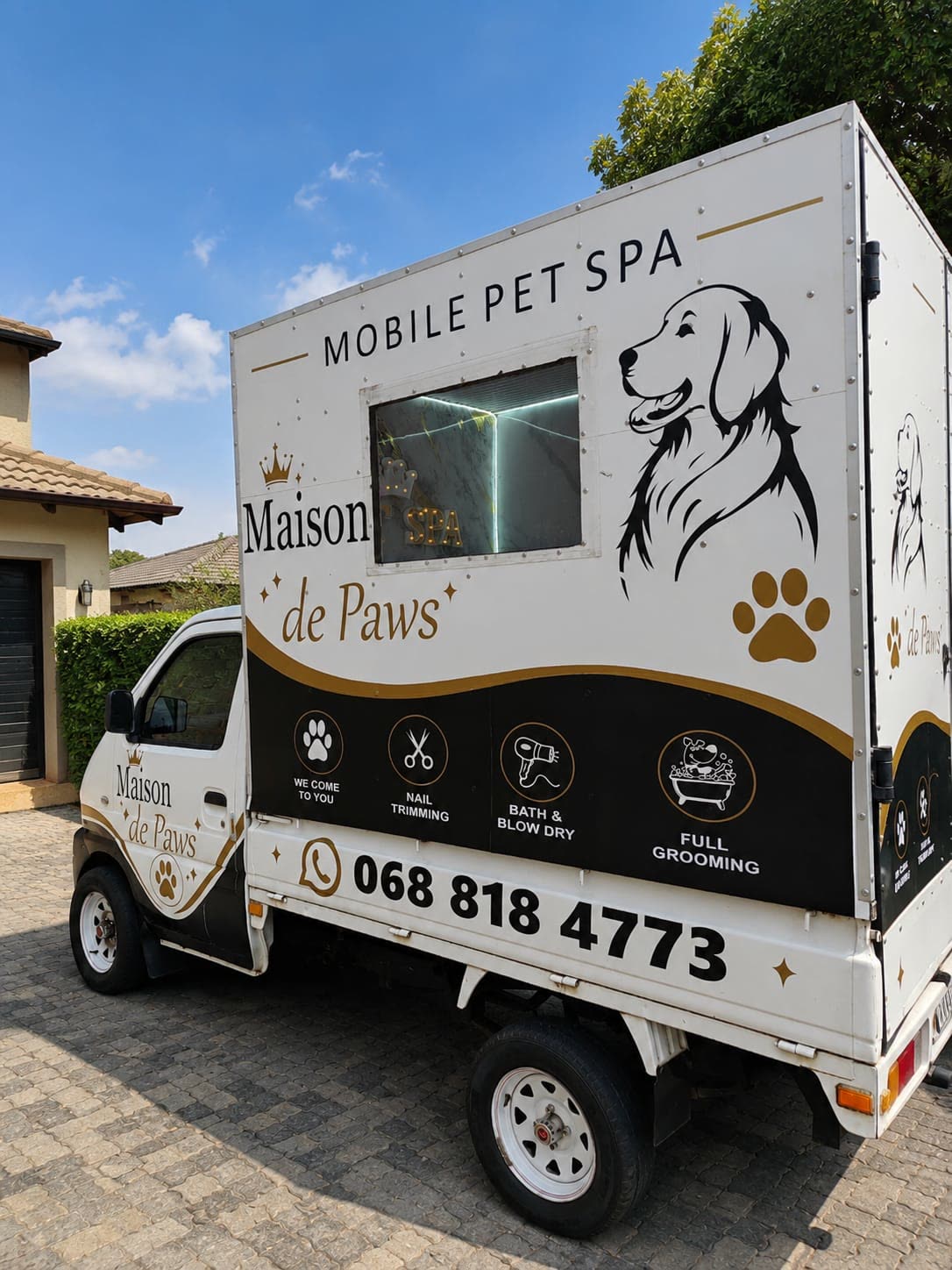 Maison De Paws mobile pet spa van, three-quarter view showing the branding