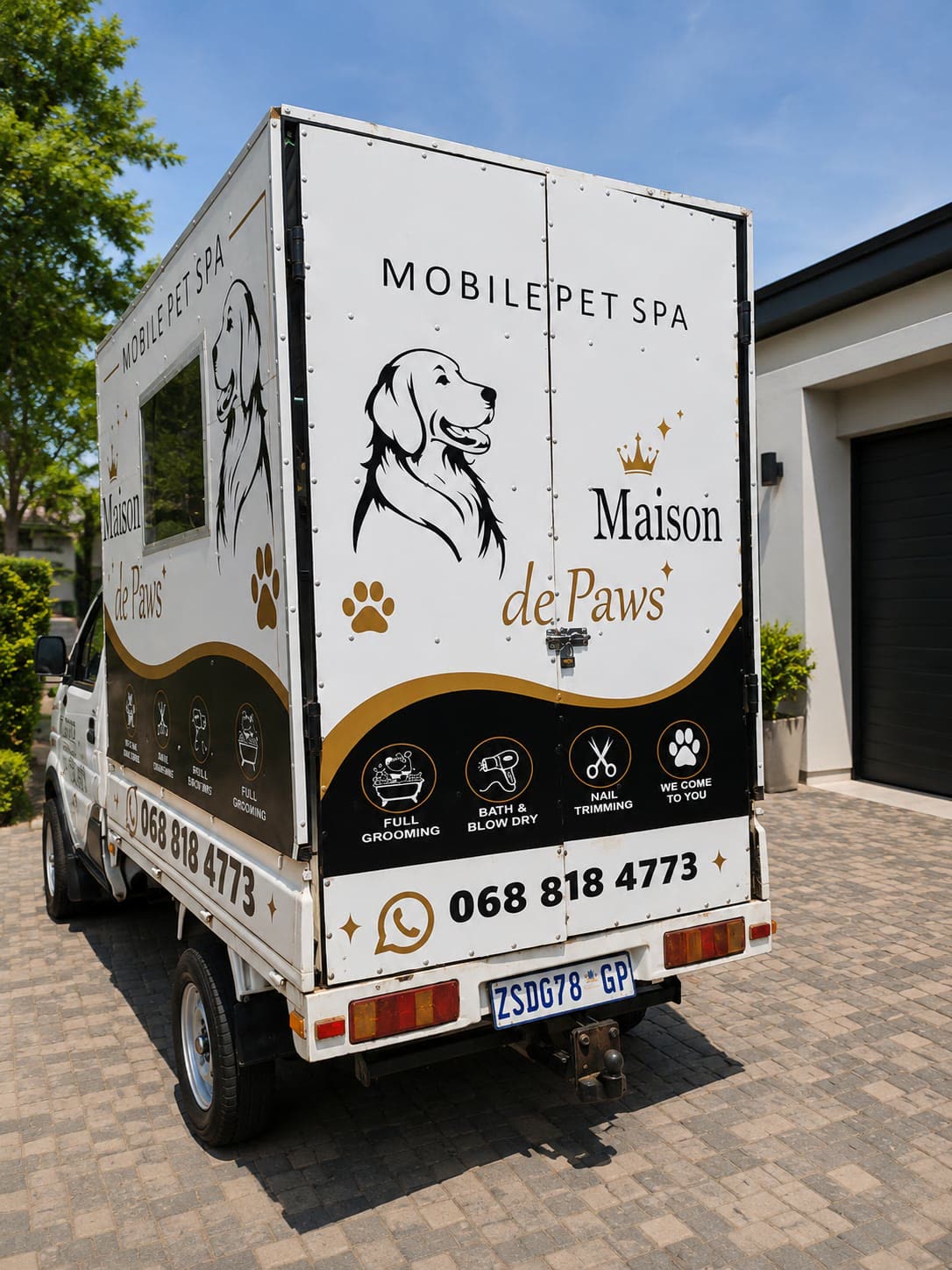Rear of the Maison De Paws van with pet spa signage and contact details